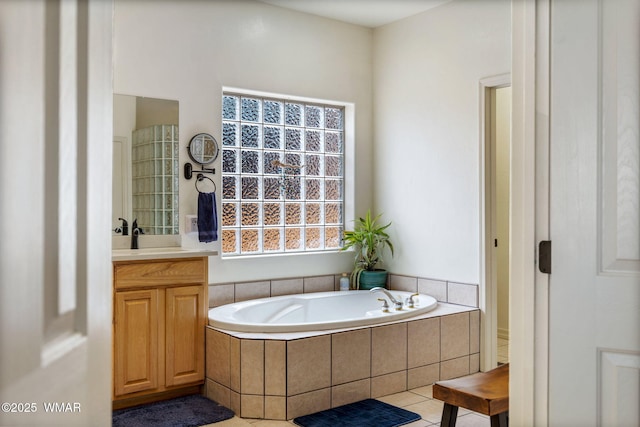 bathroom with vanity and a garden tub