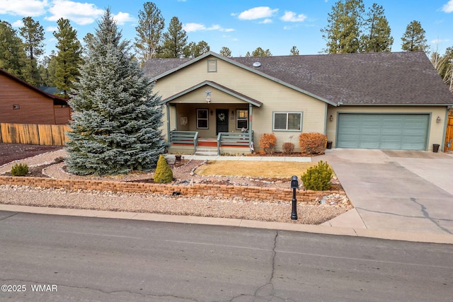 view of front of property featuring a porch, a garage, and driveway