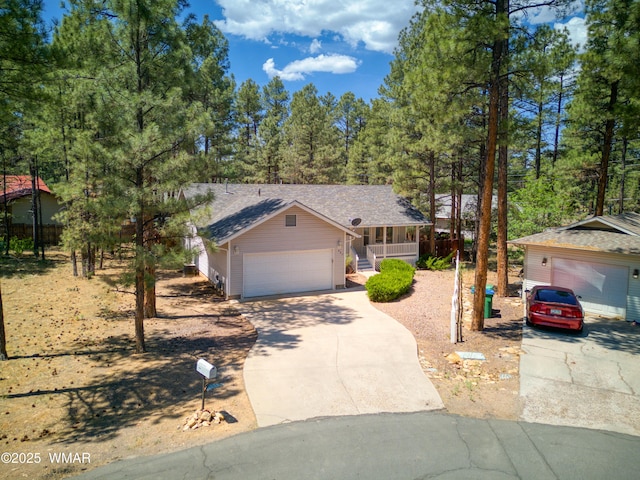 880 N 46th Dr, Show Low, AZ 85901 - view of front facade with covered porch, driveway, roof with shingles, and an attached garage