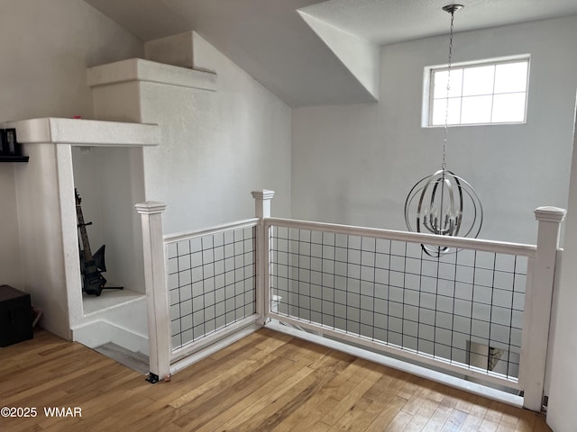 8515 Pueblo Ln, Snowflake, AZ 85937 - hall featuring a chandelier, wood-type flooring, and an upstairs landing