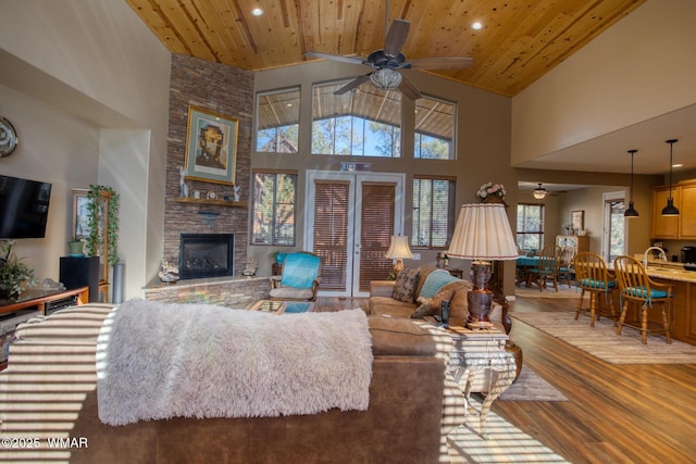 811 S Rockcress Ln, Show Low, AZ 85901 - living area featuring a ceiling fan, wood finished floors, recessed lighting, high vaulted ceiling, and a stone fireplace