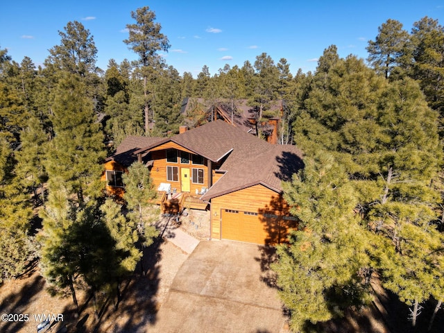 view of subject property featuring a heavily wooded area
