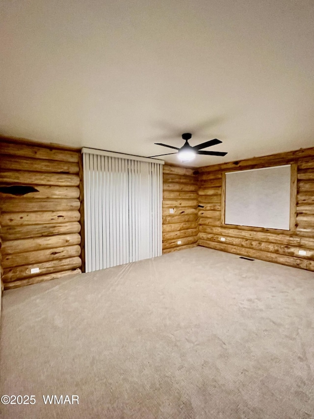 446 Becker Lake Rd, Springerville, AZ 85938 - carpeted spare room with log walls, a ceiling fan, and visible vents