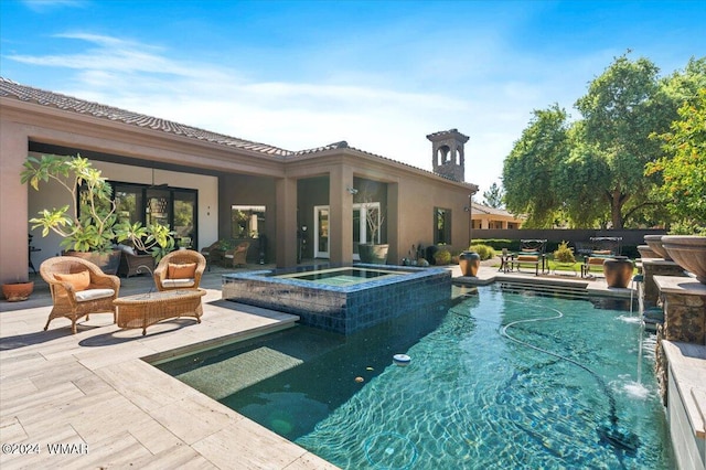 view of swimming pool featuring a pool with connected hot tub and a patio area