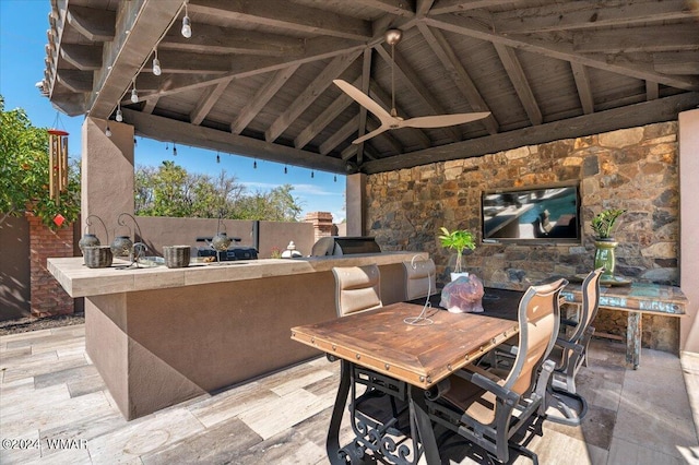 view of patio / terrace featuring a gazebo, an outdoor kitchen, and a ceiling fan