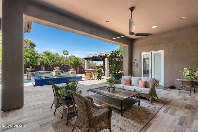 view of patio with a ceiling fan, a fenced backyard, an outdoor hangout area, an in ground hot tub, and a gazebo