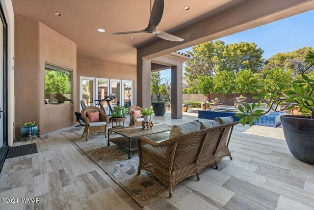 view of patio featuring an outdoor hangout area, fence, and a ceiling fan