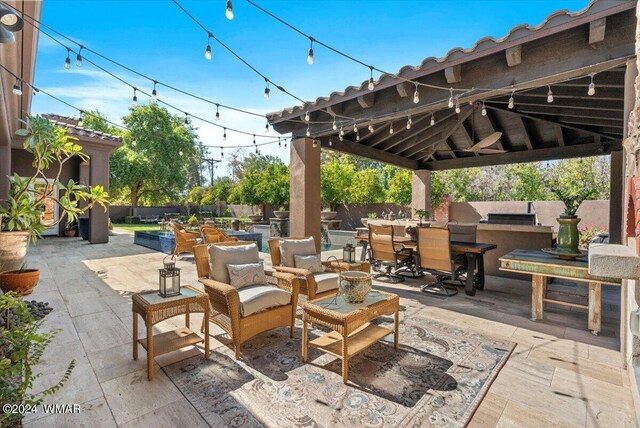 view of patio featuring a gazebo, outdoor dining space, and fence