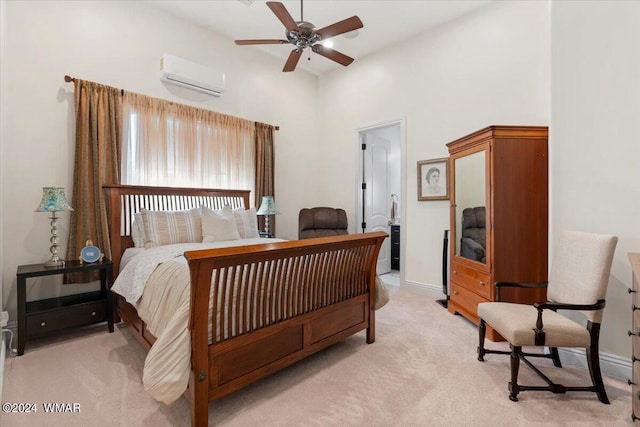 bedroom with light carpet, baseboards, and a wall mounted air conditioner