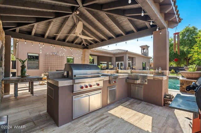 view of patio with grilling area, a gazebo, a sink, ceiling fan, and exterior kitchen