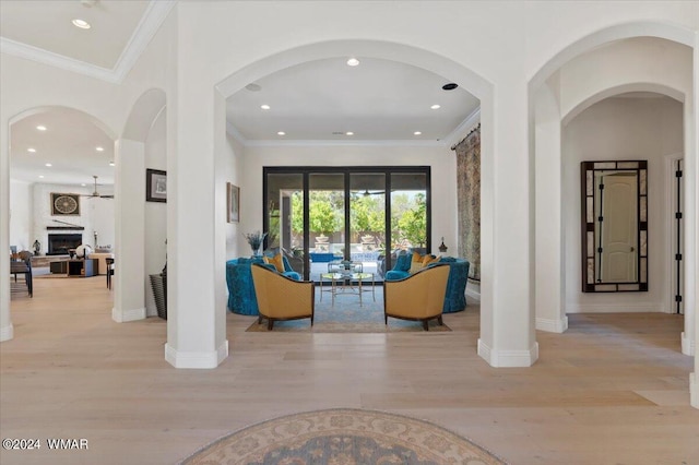 interior space featuring baseboards, recessed lighting, light wood-style flooring, and crown molding