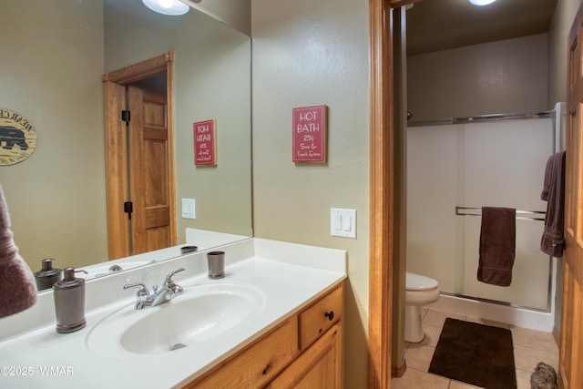 bathroom with vanity, toilet, tile patterned floors, and a stall shower