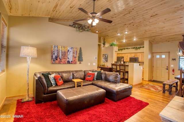 living area featuring wood ceiling, ceiling fan, vaulted ceiling, baseboards, and light wood finished floors