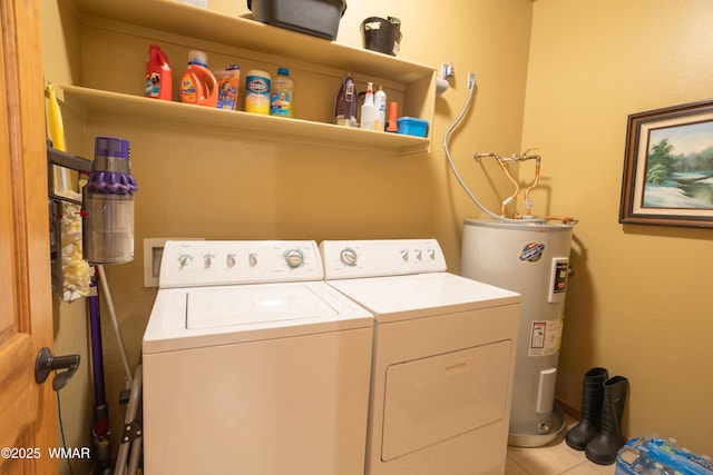 clothes washing area featuring laundry area, independent washer and dryer, tile patterned flooring, and electric water heater