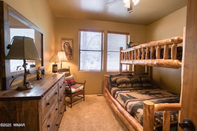 bedroom featuring multiple windows and carpet