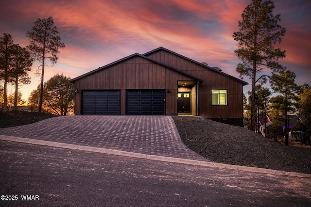 view of front of house featuring decorative driveway and an attached garage