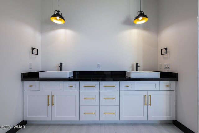 bathroom with a sink and baseboards