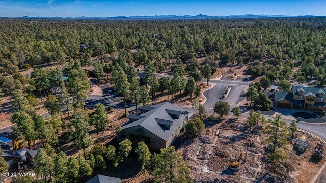 drone / aerial view with a mountain view and a wooded view