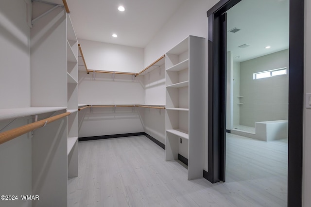 walk in closet with light wood-style flooring and visible vents