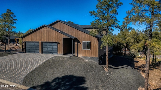 view of front of house with a garage and decorative driveway