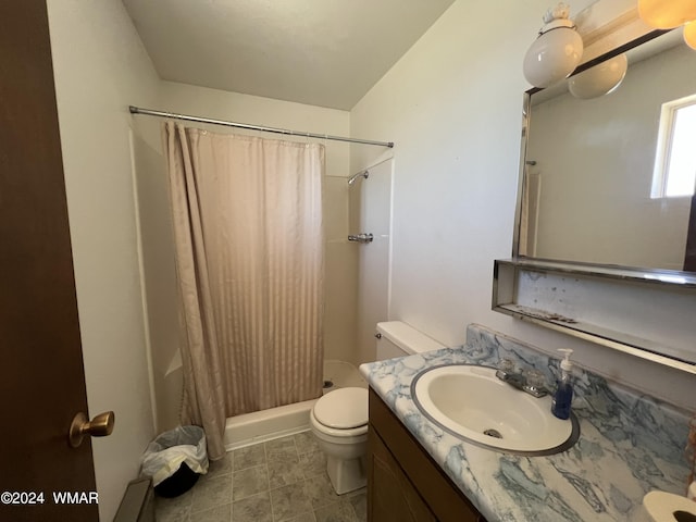 full bathroom with a stall shower, vanity, toilet, and tile patterned floors