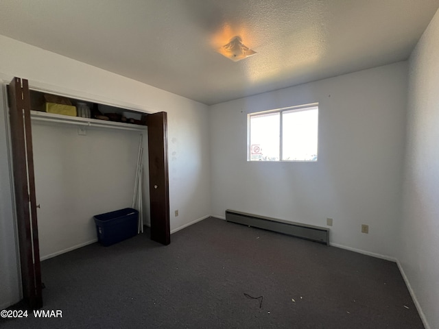 unfurnished bedroom with a baseboard radiator and baseboards