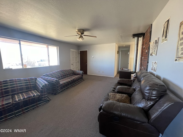 carpeted living area featuring a ceiling fan, a textured ceiling, and baseboards