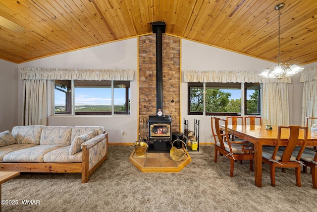 carpeted dining area with a wood stove, wooden ceiling, vaulted ceiling, and baseboards