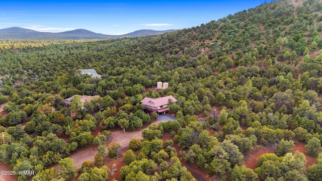 birds eye view of property featuring a forest view and a mountain view