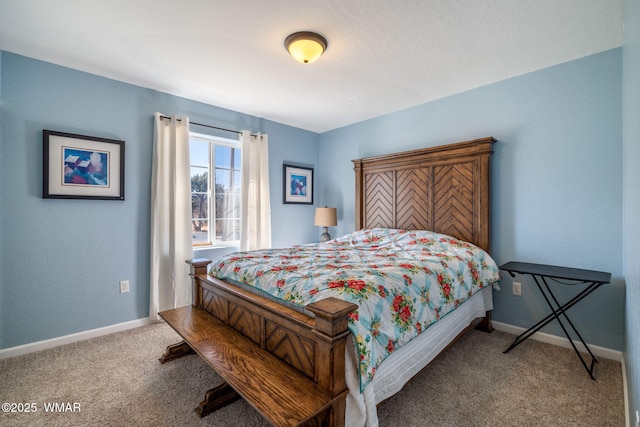 bedroom featuring carpet and baseboards