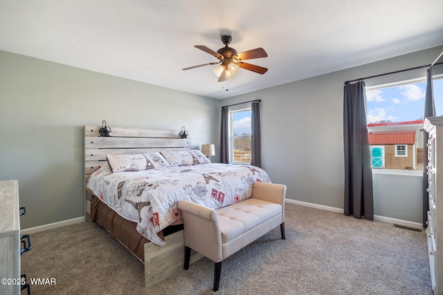 bedroom featuring a ceiling fan, carpet, visible vents, and baseboards