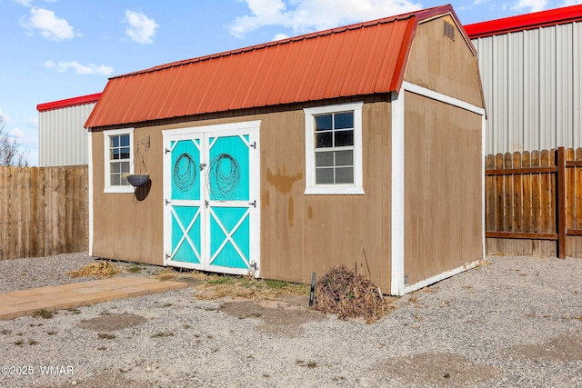 view of shed featuring fence