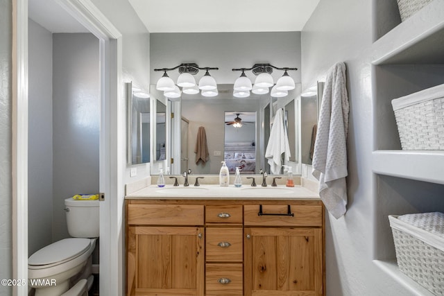 ensuite bathroom with ensuite bathroom, a sink, toilet, and double vanity