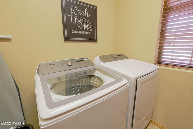 clothes washing area with washer and dryer and laundry area