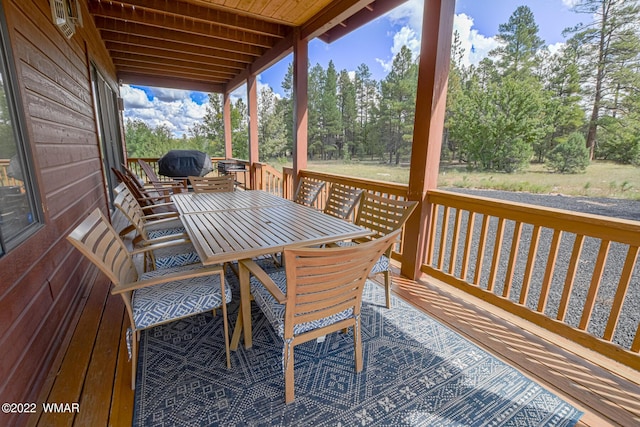 deck with outdoor dining area