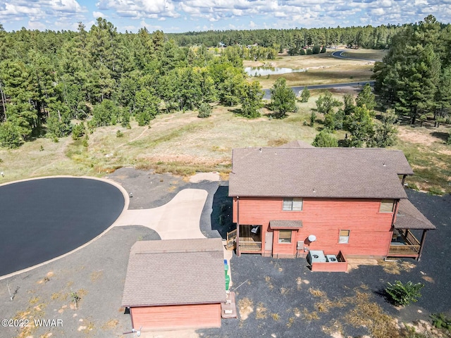 drone / aerial view with a wooded view