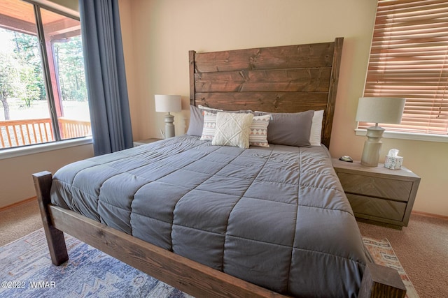 carpeted bedroom featuring baseboards