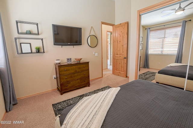 bedroom featuring baseboards and light colored carpet