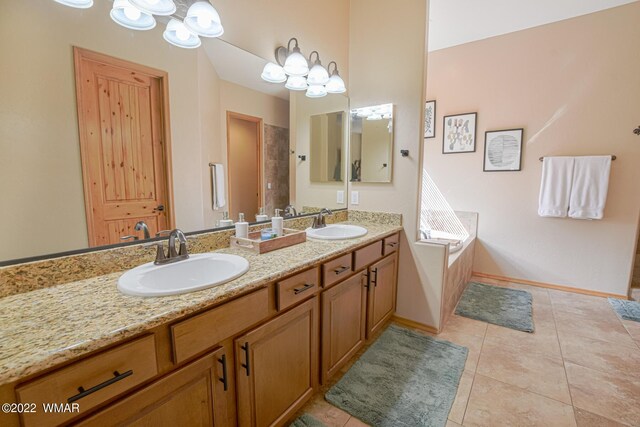 bathroom featuring tile patterned flooring, a garden tub, a sink, and double vanity