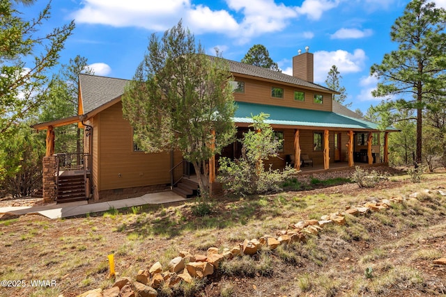 2320 Chandelle Ln, Overgaard, AZ 85933 - back of property featuring a chimney, crawl space, and a porch