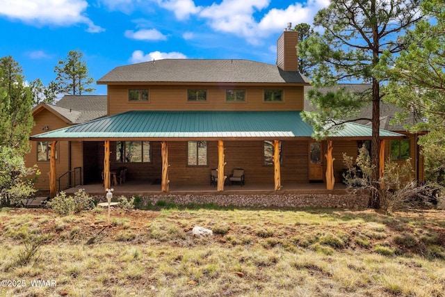 2320 Chandelle Ln, Overgaard, AZ 85933 - rear view of property featuring a chimney and a lawn