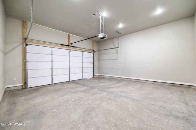 garage with baseboards and a garage door opener