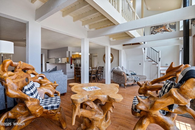 3060 Beaufeaux Ridge Rd, Overgaard, AZ 85933 - miscellaneous room featuring stairs, wood finished floors, beamed ceiling, and a towering ceiling