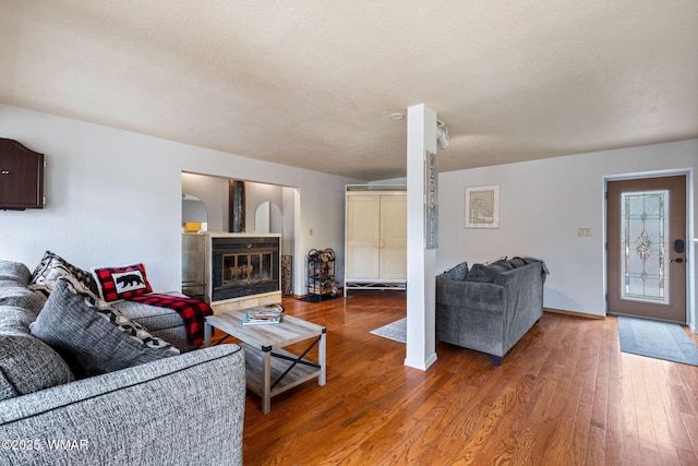 3060 Beaufeaux Ridge Rd, Overgaard, AZ 85933 - living area with wood finished floors, a tile fireplace, and baseboards