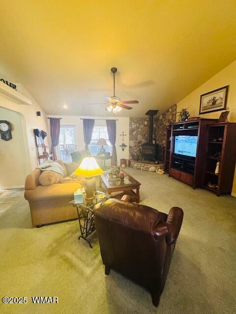 6843 Lucky Ln, Show Low, AZ 85901 - living area featuring a wood stove, carpet flooring, lofted ceiling, and a ceiling fan