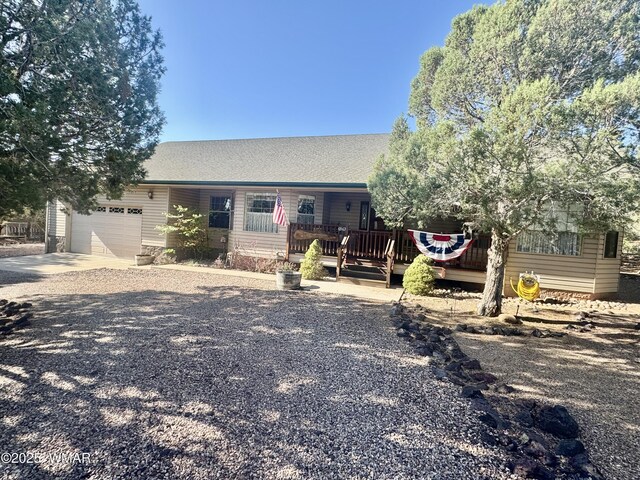 6843 Lucky Ln, Show Low, AZ 85901 - view of front of house with driveway, a garage, and a wooden deck