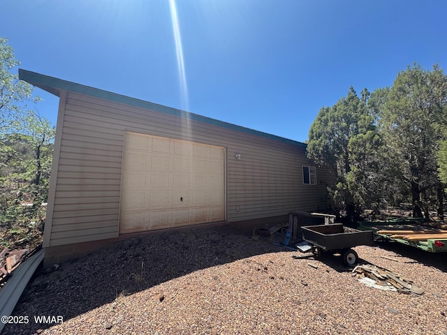 6843 Lucky Ln, Show Low, AZ 85901 - view of side of property with a garage, an outbuilding, and dirt driveway