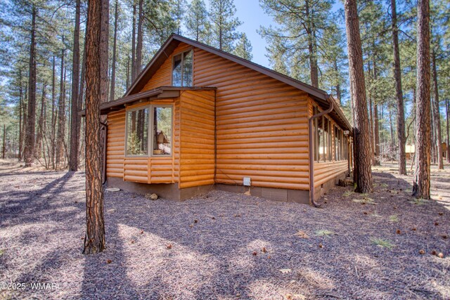 view of side of home with faux log siding