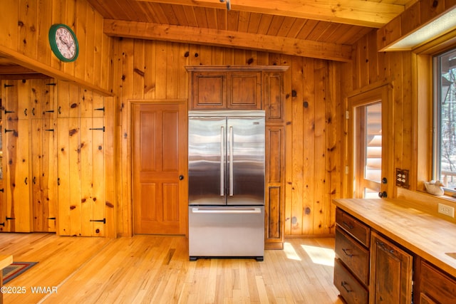 kitchen with stainless steel built in fridge, light wood-style floors, and a healthy amount of sunlight