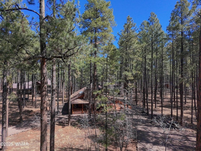 exterior space featuring a wooded view